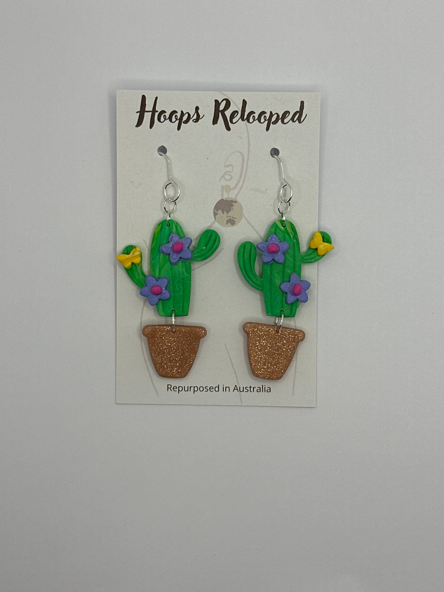 Green cactus with purple flowers