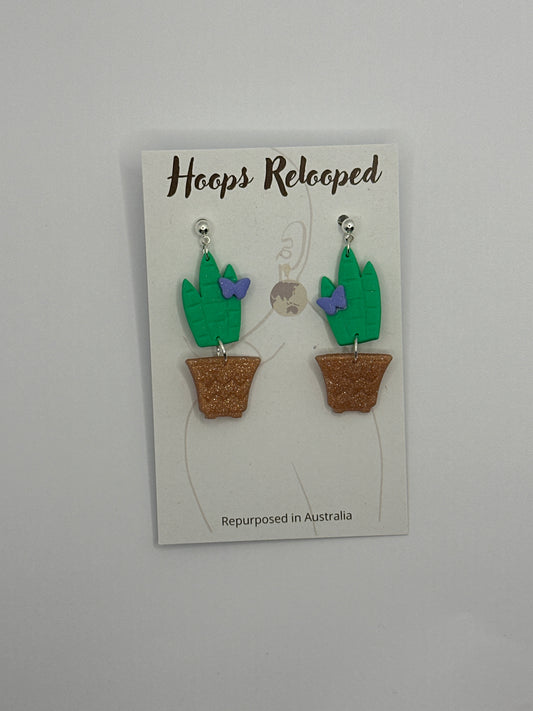 Green cactus with purple butterfly